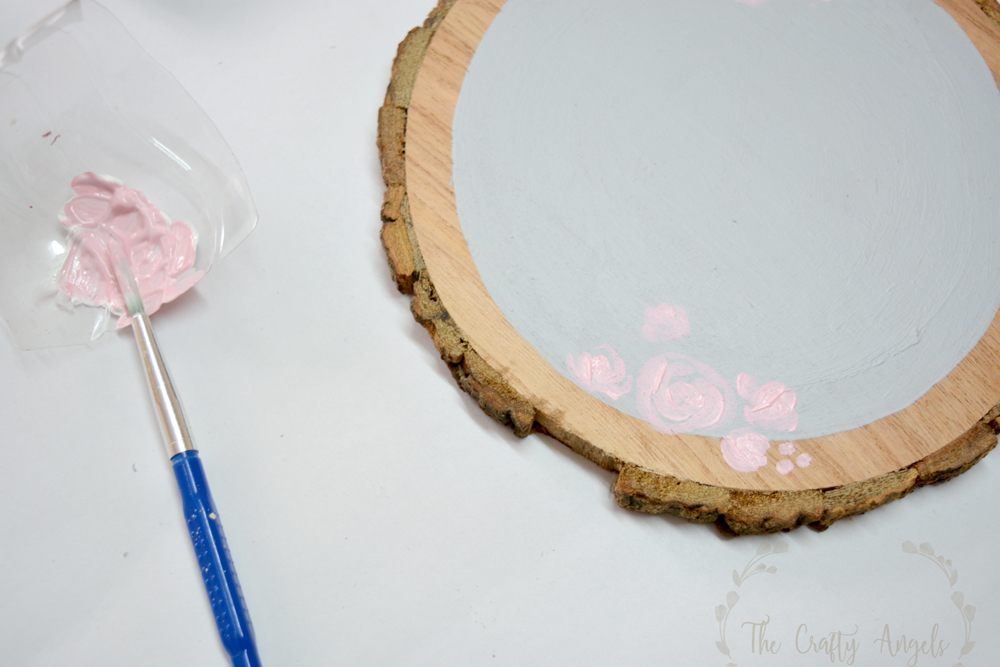 painting roses on wood slice 
